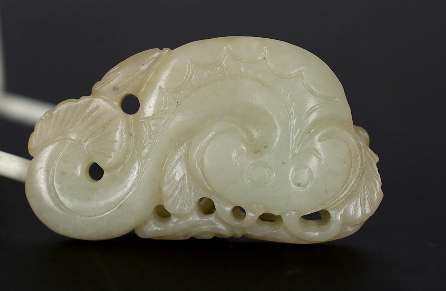 A Chinese pale celadon jade carving of a stylised catfish, probably 17th century